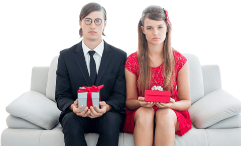 Unsmiling geeky couple holding gift boxes transparent background