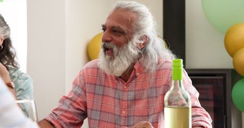 Senior Friends Enjoying Lively Discussion at Home Celebration