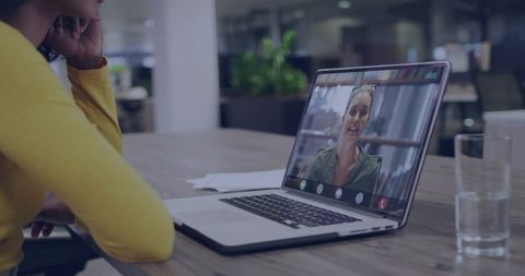 Woman Engaging in Online Meeting with Colleague in Office