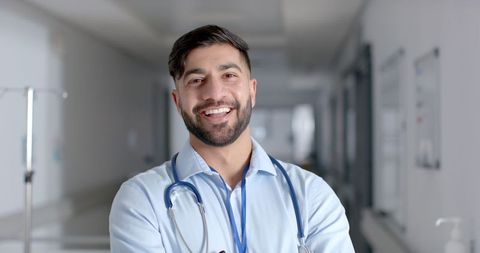Confident Young Asian Doctor Smiling in Hospital Environment