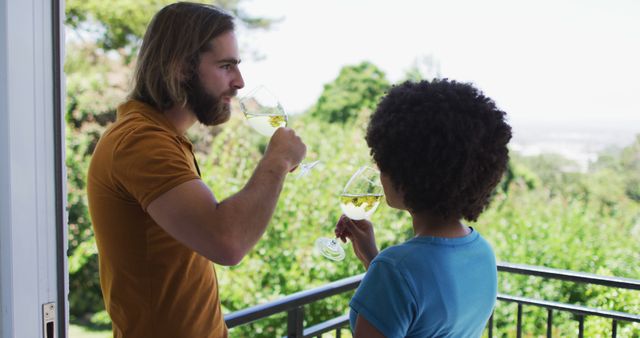 Couple enjoying wine on balcony with scenic view - Download Free Stock Images Pikwizard.com