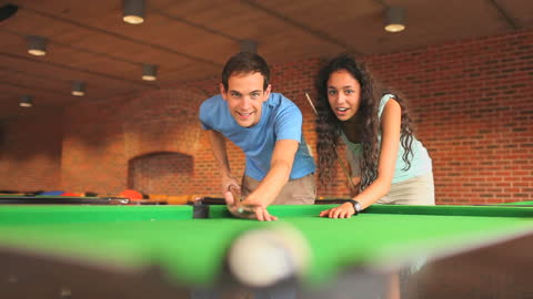 Students Enjoying Billiards Game Together Competitively