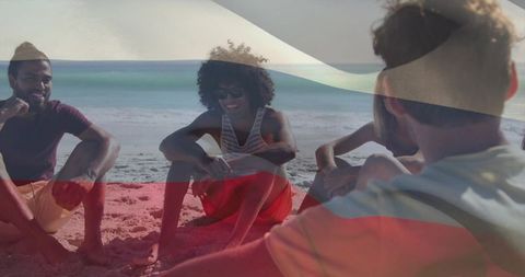 Friends chatting on beach with translucent flag overlay, casual summer coastal gathering