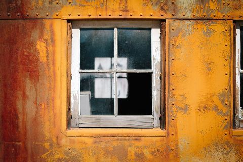 Weathered Rusty Train Car with Vintage Window