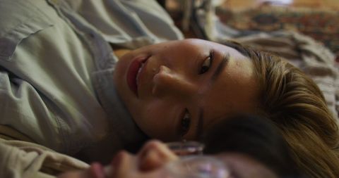 Mother and Daughter Lying Together Having Intimate Conversation