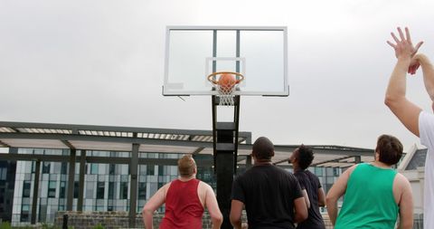 Group of Players Competing on Outdoor Basketball Court