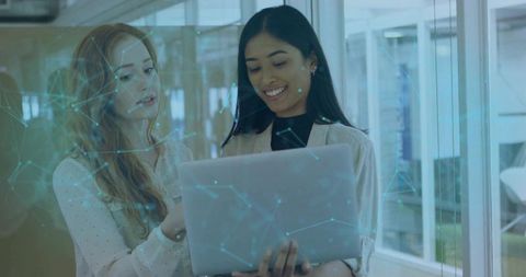 Tech Professionals Collaborating on Laptop with Digital Network Overlay