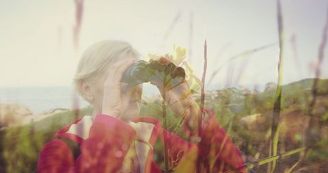 Senior Woman Birdwatching Outdoors Among Sunlit Grasses - Download Free Stock Images Pikwizard.com