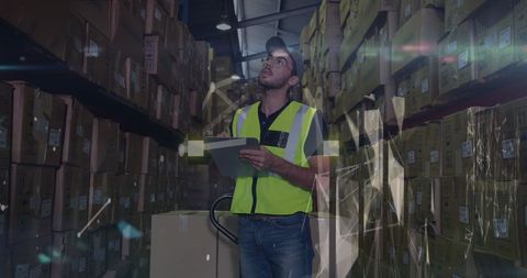 Warehouse logistics worker using digital tablet
