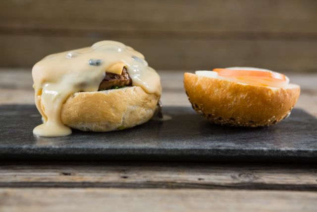 Close up of vegetable and sauce with buns on slate at table