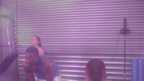 Diverse Group Using Kettlebells in Stylish Gym Interior