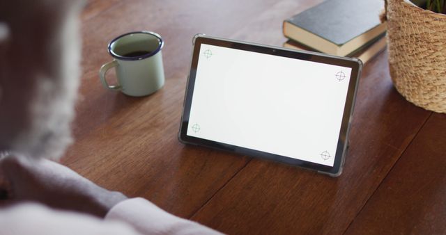 Person Drinking Coffee While Using Digital Tablet at Wooden Table - Download Free Stock Images Pikwizard.com