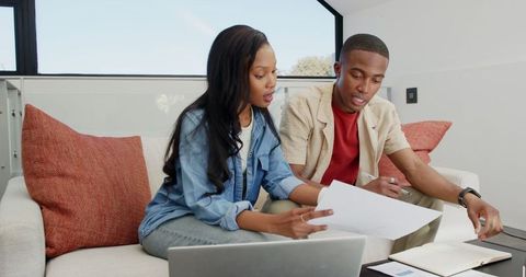 Couple Collaborating on Home Budget in Relaxed Living Room