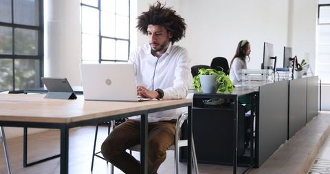 Focused Professionals Collaborating in Modern Office Workspace