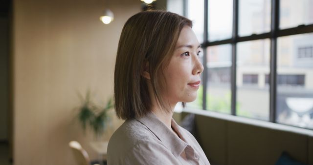 Confident Businesswoman Contemplating Future in Modern Office - Download Free Stock Images Pikwizard.com