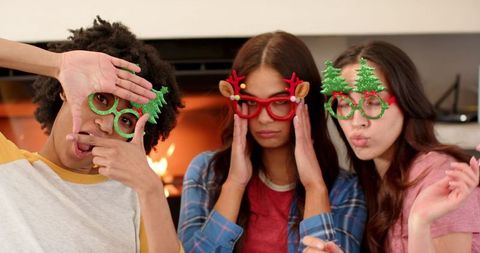 Diverse female friends celebrating christmas with festive glasses