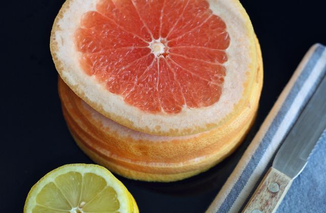 Close-up of Sliced Grapefruit and Lemon on Black Background - Download Free Stock Photos Pikwizard.com