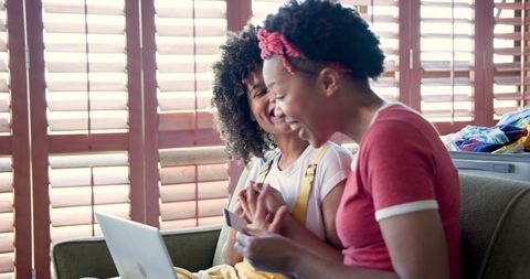 Happy Women Shopping Online Using Laptop and Credit Card