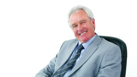 Senior Businessman Smiling Inspiratively at Office Call