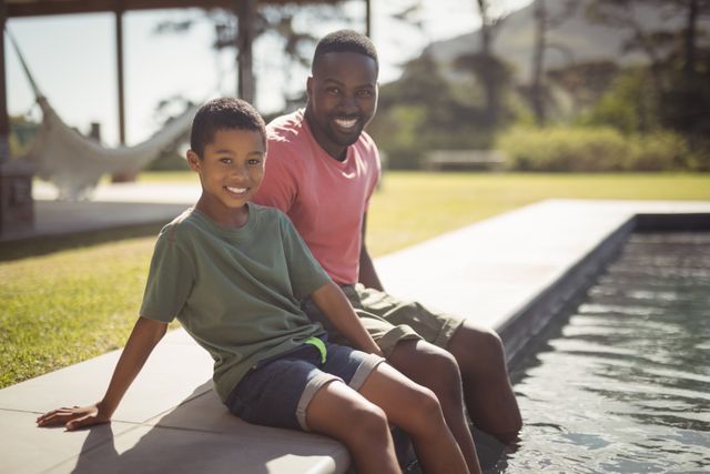 Father and son enjoying a sunny day by the swimming pool. Perfect for themes of family bonding, summer activities, outdoor leisure, and parent-child relationships. Ideal for use in advertisements, family-oriented content, and lifestyle blogs.