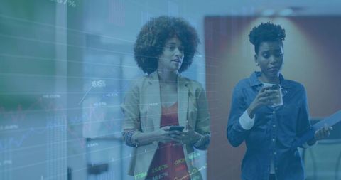 Colleagues walking with smartphone and coffee while reviewing digital analytics charts