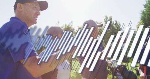 Four Golfers Standing on Sunlit Fairway Chatting and Preparing to Swing with Clubs