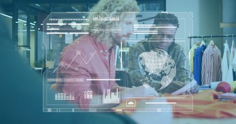 Fashion Designers Collaborating with Digital Interface in Modern Studio