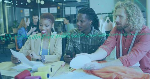 Diverse designers collaborating on fashion project in modern office