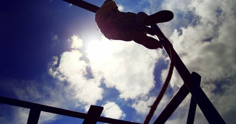 Silhouetted Child Climbing Rope Ladder Against Blue Sky - Download Free Stock Images Pikwizard.com