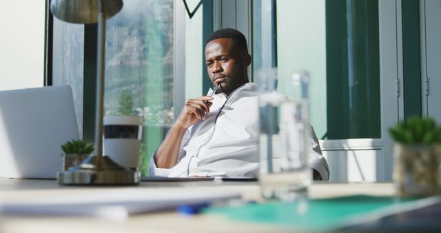 Thoughtful Businessman Working in Bright Modern Office - Download Free Stock Images Pikwizard.com