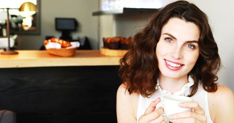 Smiling Woman Enjoying Coffee at Cozy Café - Download Free Stock Images Pikwizard.com