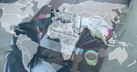 Designer Working in Modern Home Office with Digital Global Map Overlay