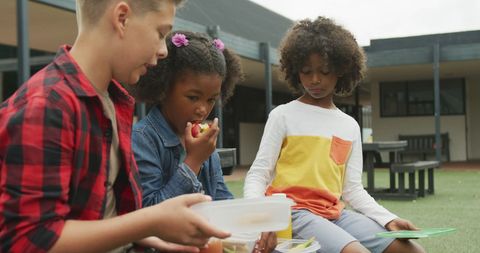 Diverse Children Enjoying Lunchtime at School Playground