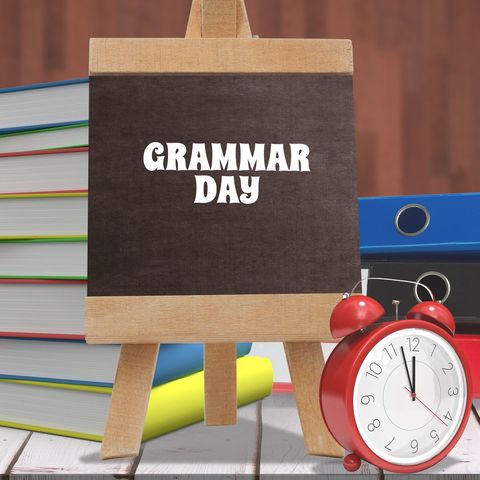 grammar day concept with desk clock and books - Download Free Stock Templates Pikwizard.com