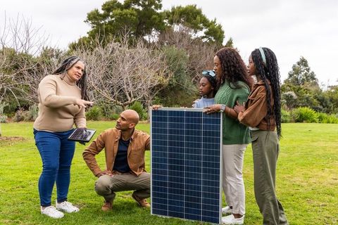 African american multigenerational family demonstrating solar panels for sustainable living educatio