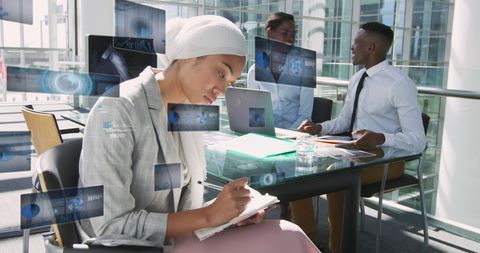 Diverse team working with advanced digital tools in corporate setting