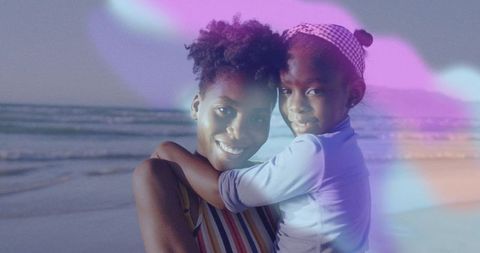 Mother Holding Daughter with Lens Flare at Serene Beach