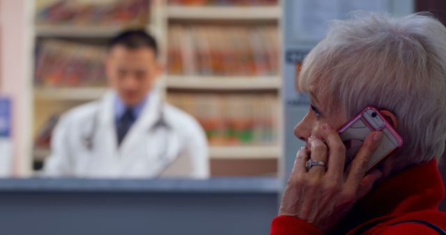 Senior Woman Talking on Phone at Clinic Reception Desk - Download Free Stock Images Pikwizard.com