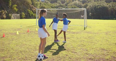 Girls Celebrating Soccer Goal on School Field