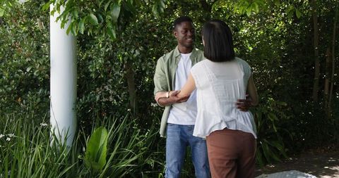 Joyful Couple Embracing in Lush Green Garden
