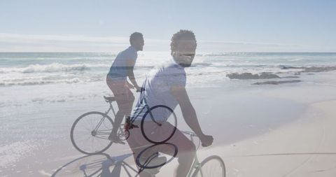 Young man biking along serene beach shore