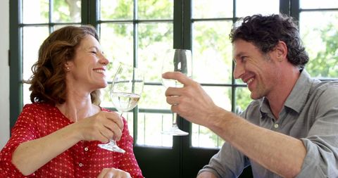 Couple Toasting Wine Glasses in Restaurant Setting - Download Free Stock Images Pikwizard.com