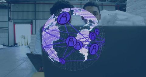 Warehouse team analyzing holographic global network on laptop for logistics analytics
