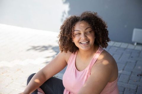 Smiling Woman in Athletic Wear Enjoying Outdoor Leisure Time