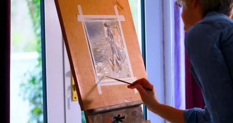Female Artist Refining Canvas Painting with Brush