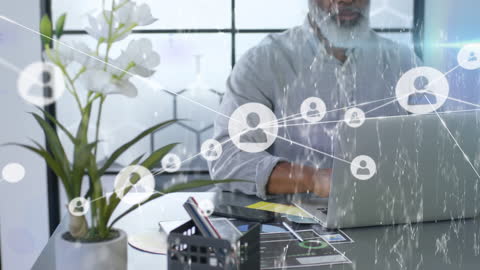 Senior Man Exploring Networking Concepts on Laptop in Office