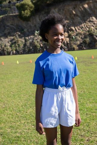 Teen Athlete on Sports Field Smiling Brightly
