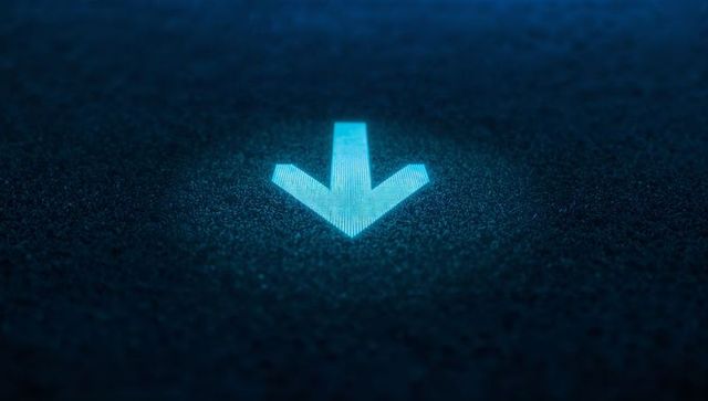 Glowing cyan down arrow pointing on textured asphalt with digital scanline halo