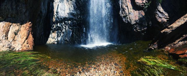 Scenic Waterfall Cascading Over Rocky Cliff into Clear Pool - Download Free Stock Photos Pikwizard.com