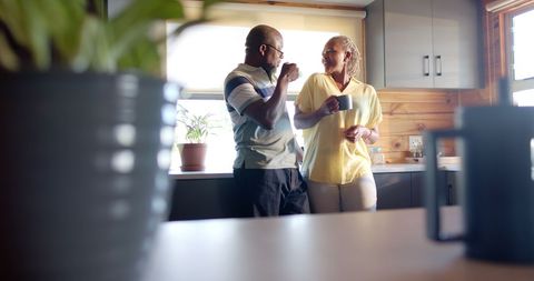 Senior Couple Enjoying Coffee in Bright Kitchen Setting